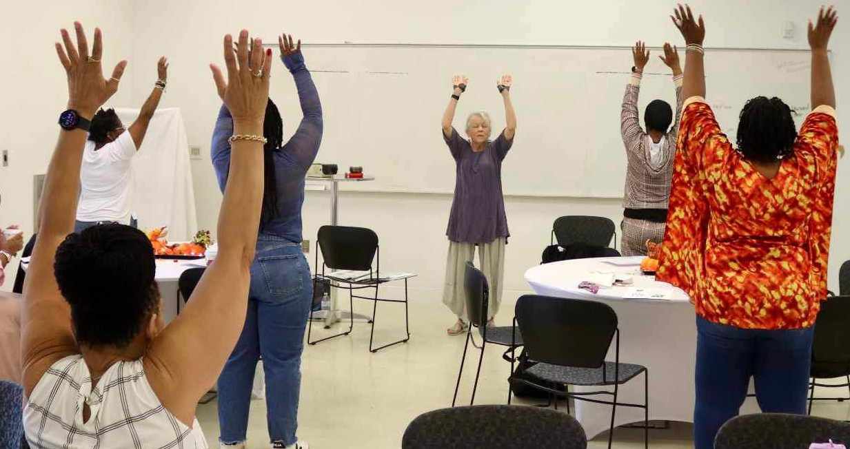 Group of people practicing Qi Gong.